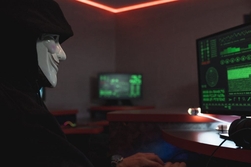 person on computer hacking into a business
